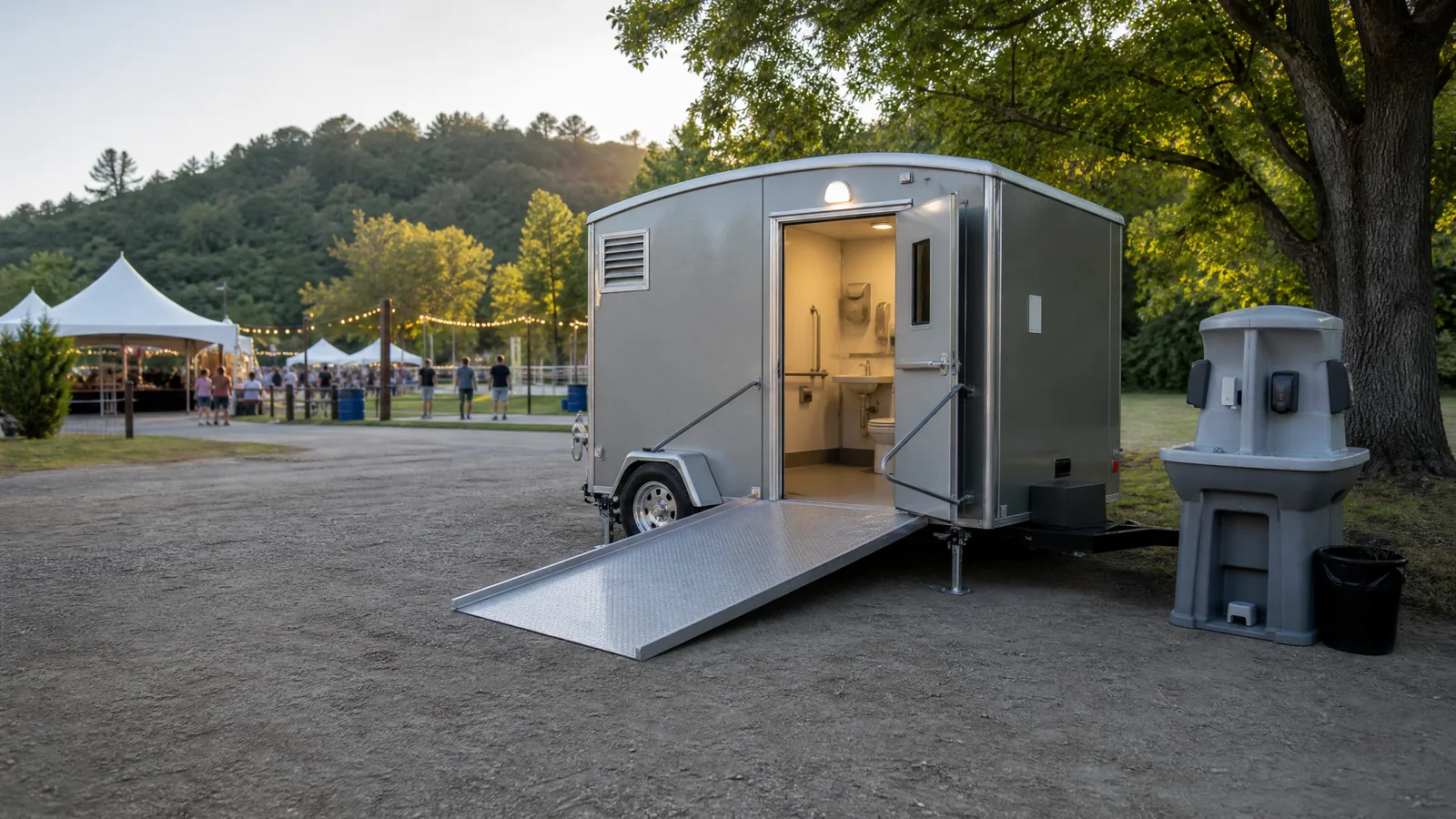An accessible portable restroom and handwashing station at an outdoor event.